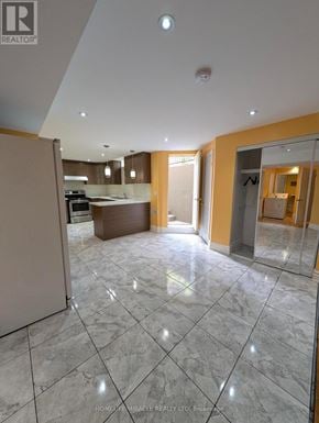 Caledon apartment for rent - A spacious kitchen and living room with marble flooring and modern appliances.