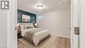 Guelph apartment for rent - A bedroom with a bed, pillows, and a picture on the wall.