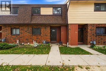 Hamilton (Gilkson) townhouse for rent - A brick house with a red door and a brown door.