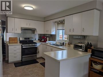 Hamilton apartment for rent - A kitchen with white cabinets and a large island.