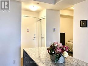 Richmond Hill (Langstaff) condo for rent - A room with a marble counter top and a vase of flowers.