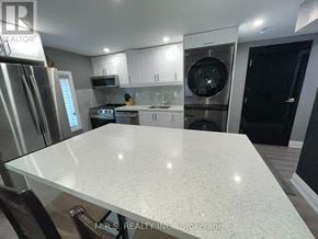 Brampton (Queen Street Corridor) apartment for rent - A modern kitchen with a large island in the center.