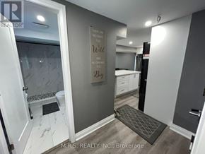 Brampton (Queen Street Corridor) apartment for rent - A bathroom with a glass shower door and a toilet in the corner.