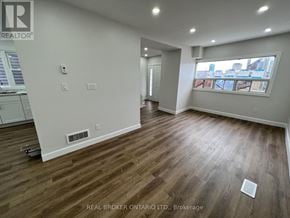 Hamilton (Crown Point) apartment for rent - A room with wood flooring and a window overlooking a cityscape.