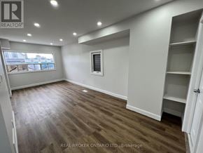 Hamilton (Crown Point) apartment for rent - A room with wooden flooring and white walls, with a window and a door visible.