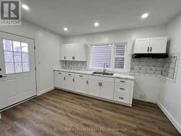 Hamilton (Crown Point) apartment for rent - A kitchen with white cabinets and a wooden floor.