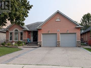Hamilton (Gurnett) apartment for rent - A red brick house with a grey garage door.