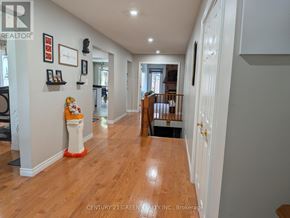 Hamilton (Gurnett) apartment for rent - A hallway with a white door and a white wall with pictures on it.
