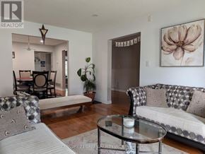 Hamilton (Gurnett) apartment for rent - A living room with a sofa, a coffee table, and a painting on the wall.
