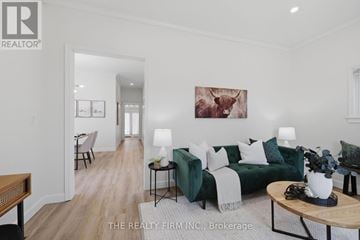 London East (East M) apartment for rent - A living room with a green couch and a painting of a cow on the wall.