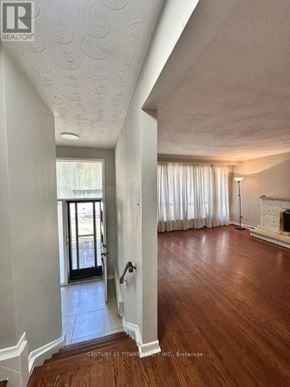 Toronto (Highland Creek) apartment for rent - A hallway with wood floors and white walls leading to a door.