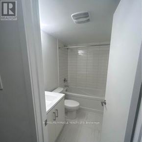 Vaughan (Vaughan Corporate Centre) townhouse for rent - A white bathroom with a toilet, sink, and shower.