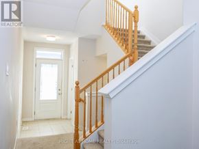 Ottawa townhouse for rent - A hallway with a staircase and a door.