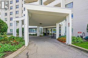 St. Catharines (Glendale/Glenridge) condo for rent - A white building with a covered walkway entrance.