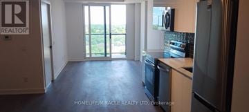 Brantford condo for rent - A kitchen with a refrigerator, oven, and microwave.