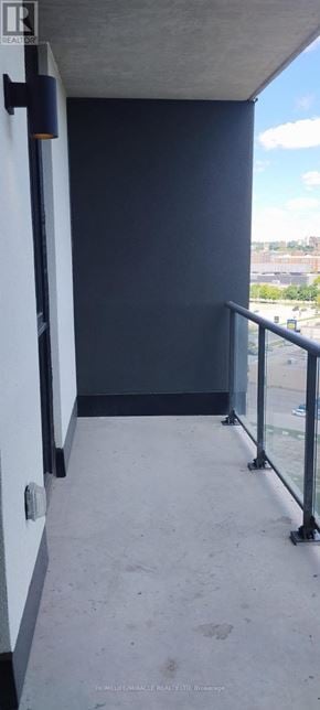 Brantford condo for rent - A balcony with a glass railing and a view of the sky.