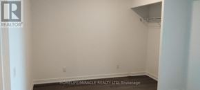 Brantford condo for rent - A white wall with a brokerage sign on it.