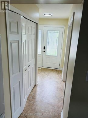 Cambridge apartment for rent - A hallway with white doors and a tiled floor.