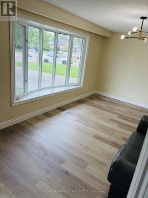 Cambridge apartment for rent - A room with a large window and a wooden floor.