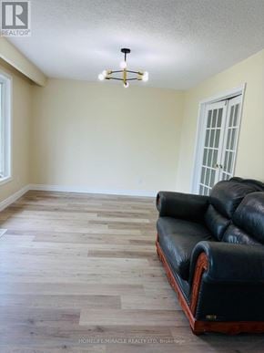 Cambridge apartment for rent - A black leather sofa with wooden legs in a room with a window.