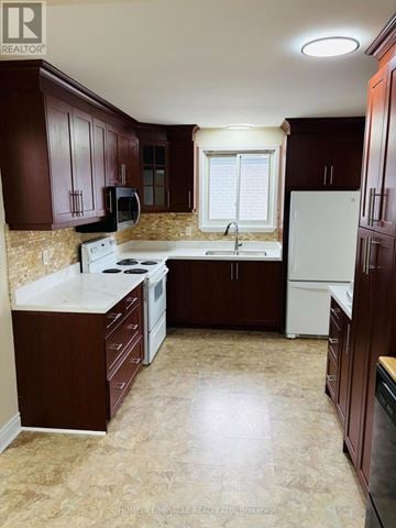 Cambridge apartment for rent - A kitchen with brown cabinets and a white stove top oven.