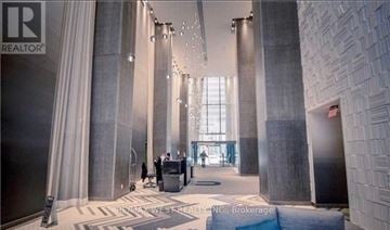 Toronto (Bay Street Corridor) condo for rent - A lobby with a lot of columns and people walking around.