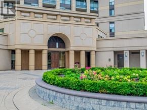 Mississauga (Hurontario) condo for rent - A building entrance with a flower bed in front.