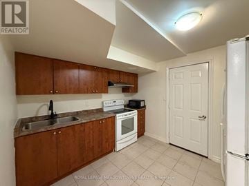 Brampton (Northwest Brampton) apartment for rent - A kitchen with white appliances and wooden cabinets.