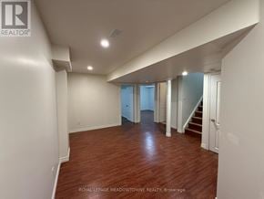 Brampton (Northwest Brampton) apartment for rent - A spacious room with wooden flooring and white walls.