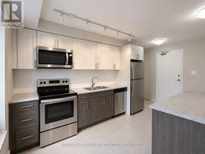 St. Catharines (Downtown) multi-family for rent - A kitchen with a stove, oven, microwave, and refrigerator.