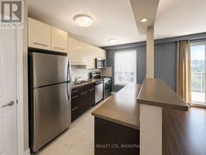 St. Catharines (Downtown) multi-family for rent - A modern kitchen with stainless steel appliances and a large island.
