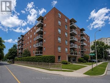 St. Catharines (Downtown) multi-family for rent - A large red brick apartment building with balconies on the upper floors.