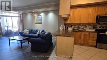 Mississauga (City Centre) condo for rent - A living room with a couch and a coffee table.