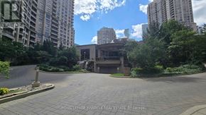 Mississauga (City Centre) condo for rent - A paved courtyard surrounded by trees and buildings.