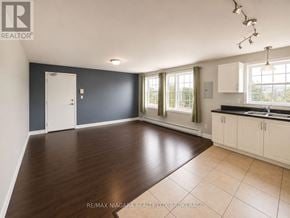 St. Catharines (E. Chester) multi-family for rent - A spacious room with a door, windows, and a sink.