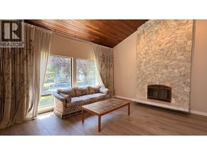 Vancouver apartment for rent - A living room with a couch, coffee table, and a stone fireplace.