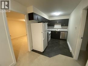 Coquitlam apartment for rent - A kitchen with a refrigerator, stove, and oven.