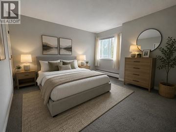 Coquitlam apartment for rent - A bedroom with a large bed, a nightstand, and a dresser.