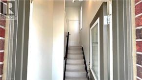 Ancaster townhouse for rent - A long hallway with a staircase leading to the second floor.