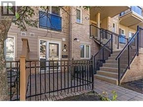 Mississauga (Churchill Meadows) townhouse for rent - A house with a black metal fence and a staircase leading to the entrance.