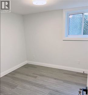 Kitchener apartment for rent - A room with a window and a wooden floor.
