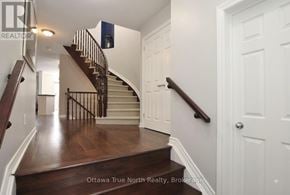 Ottawa townhouse for rent - A staircase with a wooden floor and white walls.