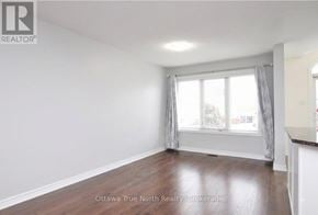 Ottawa townhouse for rent - A room with a window and a wooden floor.