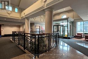 Toronto (Newtonbrook East) condo for rent - A lobby with a black wrought iron railing.