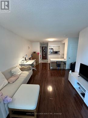 Toronto (Newtonbrook East) condo for rent - A living room with a white couch and a wooden floor.