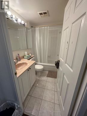 Toronto (Newtonbrook East) condo for rent - A bathroom with a toilet, sink, and shower.