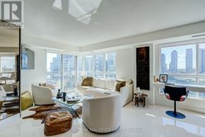 Toronto (Mimico) condo for rent - A living room with a white couch and a glass table.