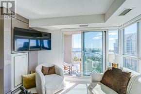 Toronto (Mimico) condo for rent - A living room with a flat screen TV mounted on the wall.