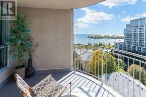 Toronto (Mimico) condo for rent - A balcony with a table and chairs overlooking a body of water.