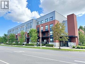 Toronto (L'amoreaux) townhouse for rent - A modern building with a glass facade and a red brick chimney.